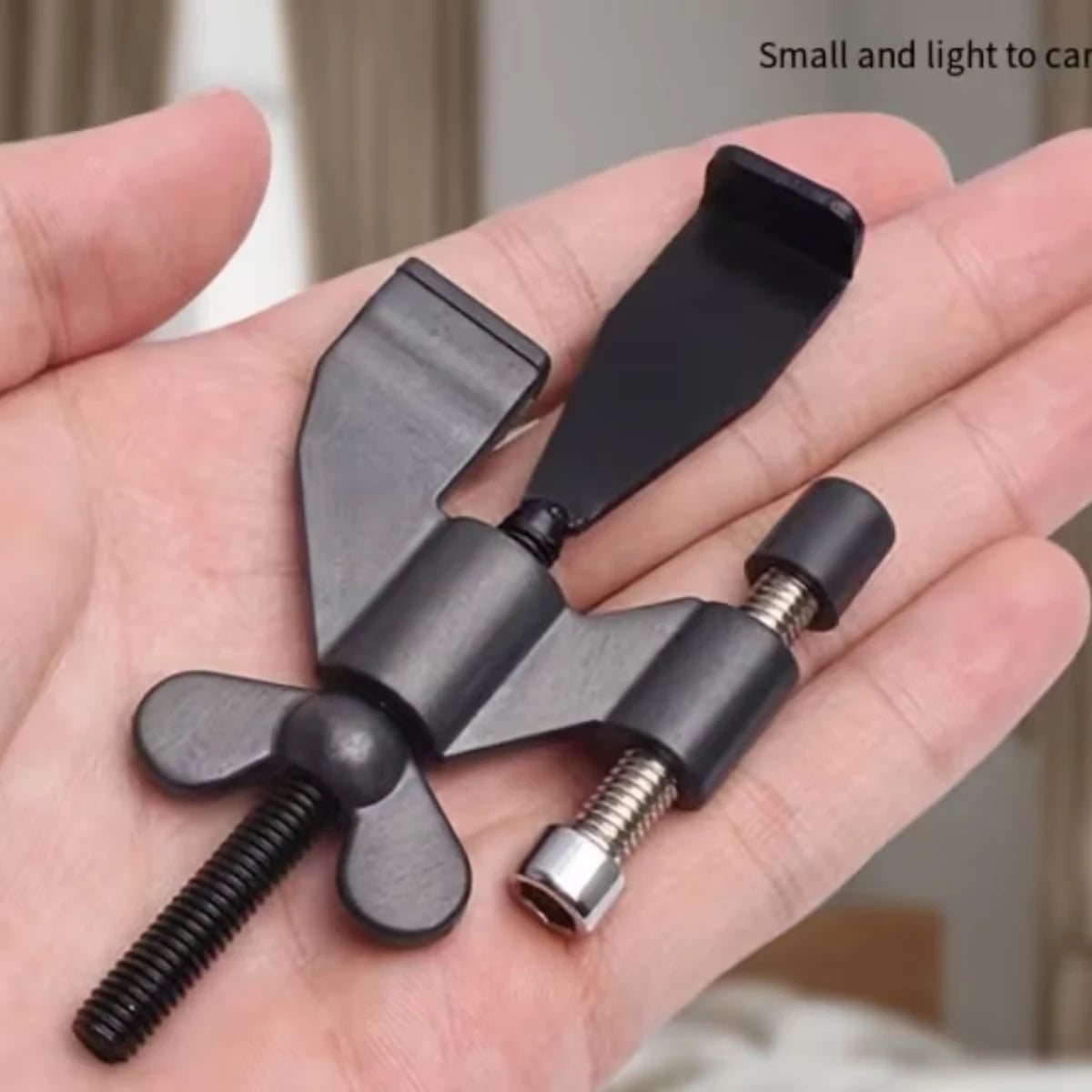 Compact adjustable Roamsafe door lock held in one hand